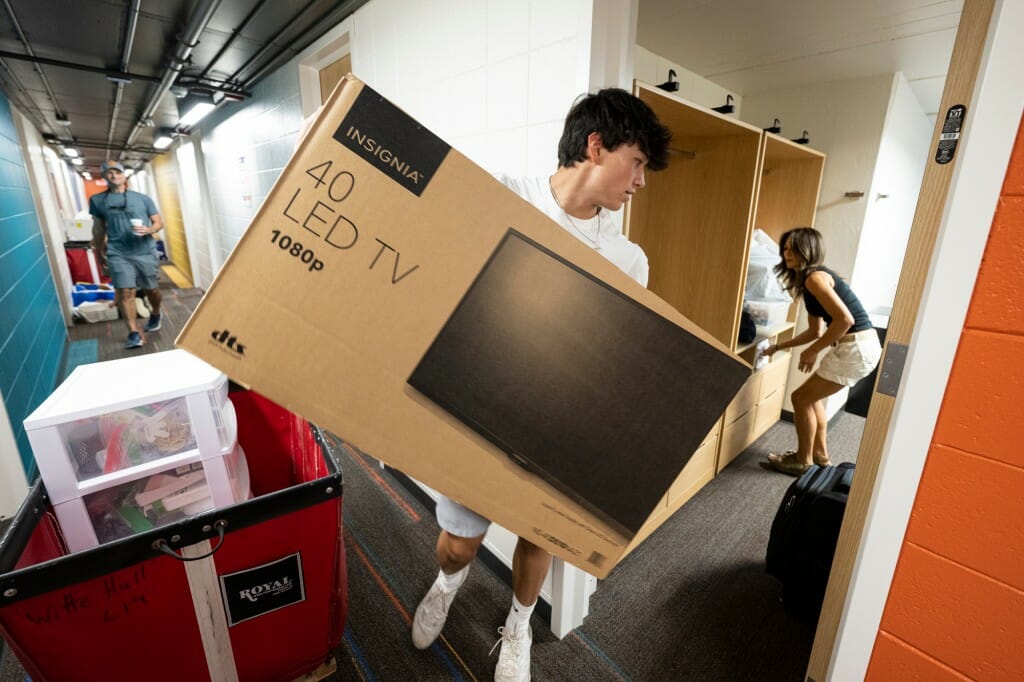 Don't forget entertainment options. First-year student Alex Kalis brings in his TV, as his mother helps him move into Witte.