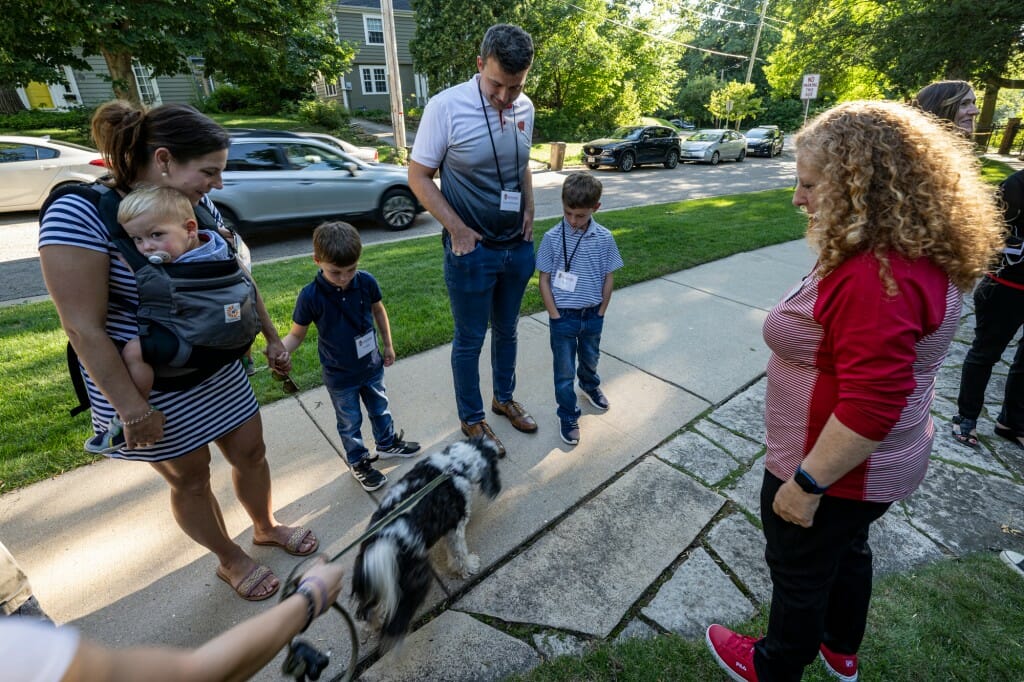 Chancellor Mnookin and her dog Plato greet Tony McDonald, assistant professor in the College of Engineering, and his family.
