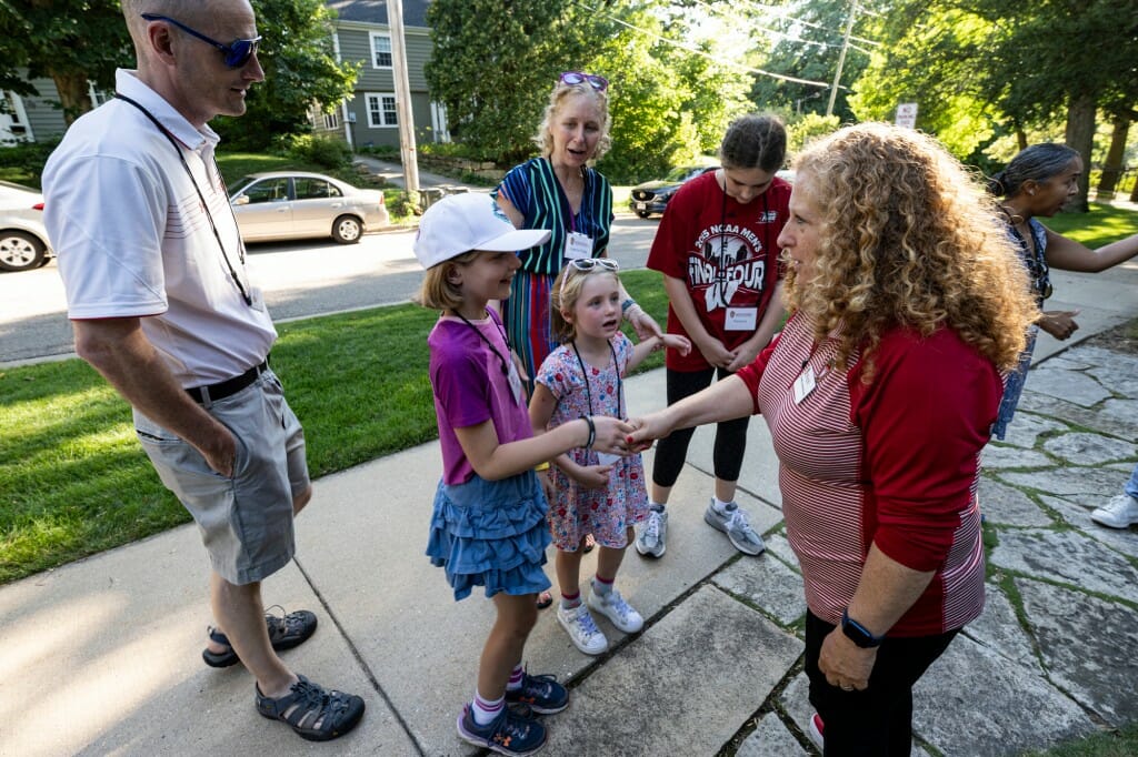 Chancellor Mnookin greets Lauren Papp, professor and associate dean in the School of Human Ecology, and her family. 