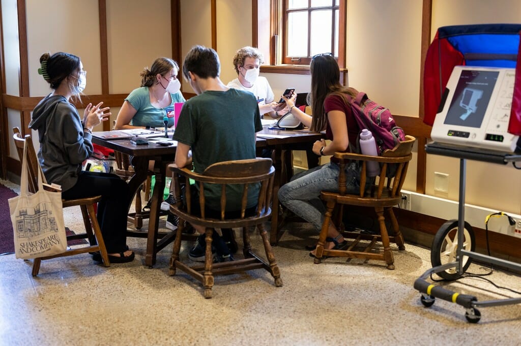 Staff from the City of Madison Clerk’s Office assist UW–Madison students registering to vote for the Aug. 9 Wisconsin primary election during early voting at a polling station in the Memorial Union. Early voting continues on campus until Friday.