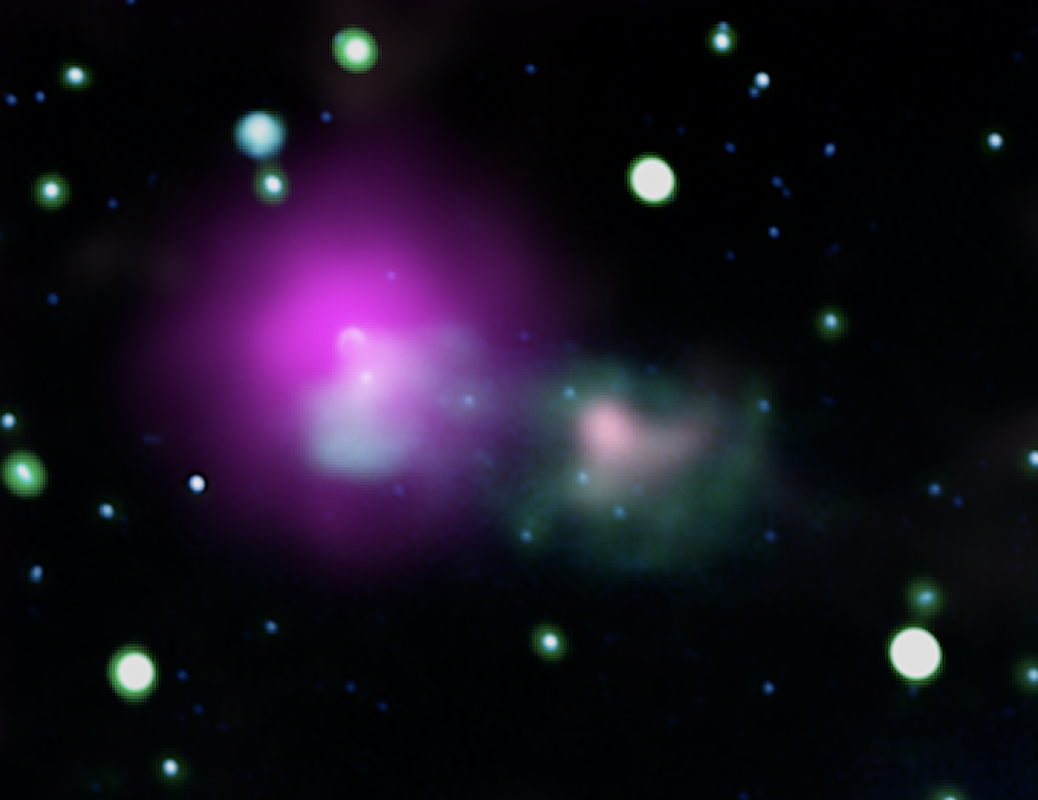telescope image of blurry stars in space around a magenta blob next to a pink smudge within a greenish cloud