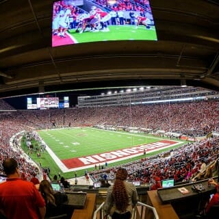 A picture of a field view along with a TV monitor view of the game.