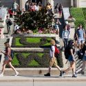 Students walk pass a flowerbed – filled with contrasting plants that form the letters U and W – in front of Agricultural Hall at the University of Wisconsin-Madison during the first day of autumn classes on Sept. 7, 2022.  (Photo by Jeff Miller / UW-Madison)