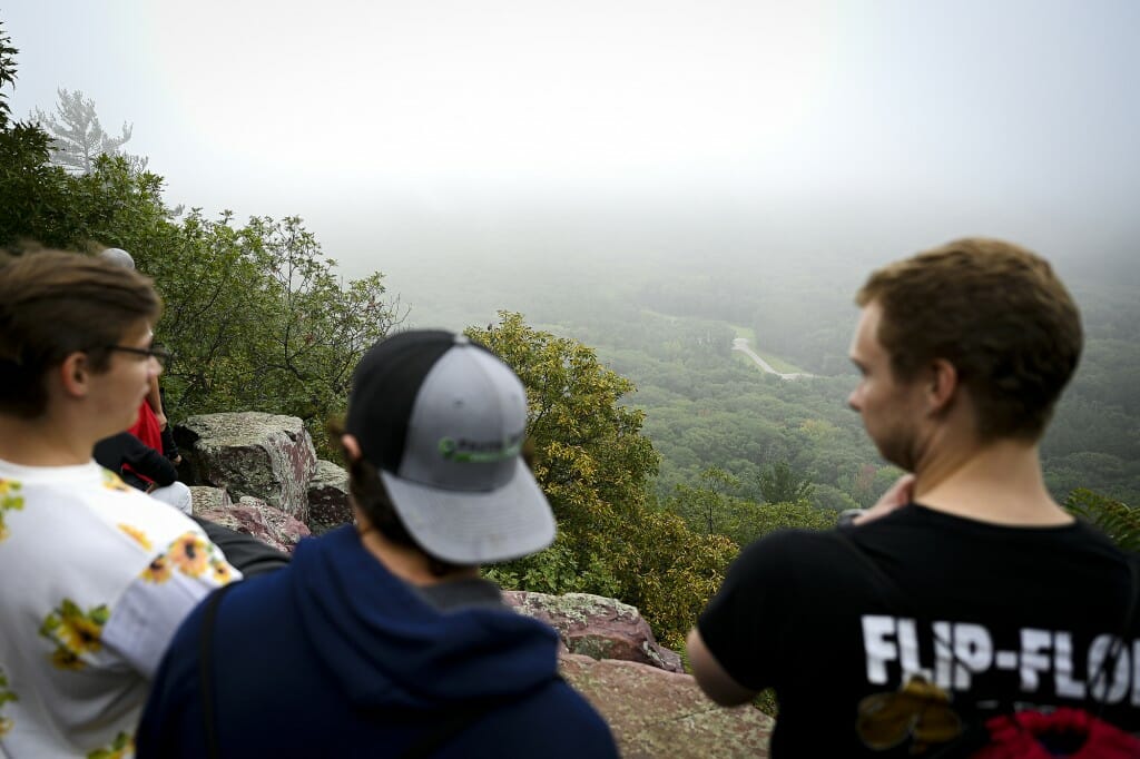 Two students enjoy a view of the landscape from a high bluff