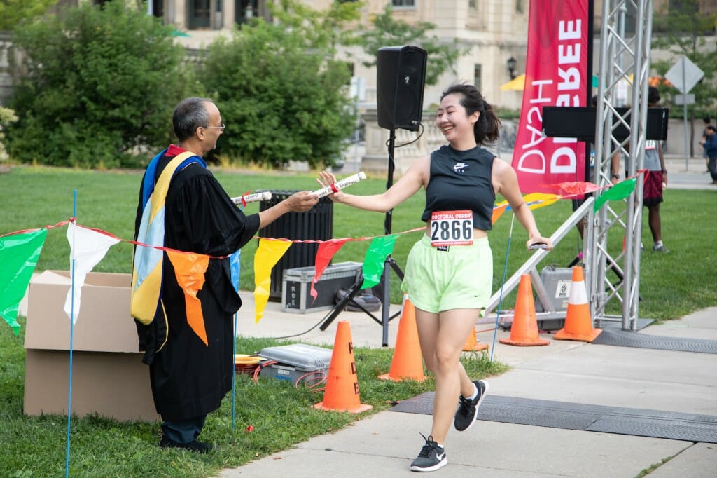 A finisher receives a (mock) diploma. Participants chose either the 5.07-mile Doctoral Derby or the 1.94-mile Master’s Mile. Race distances were based on the approximate average time to degree (in years) at UW–Madison.