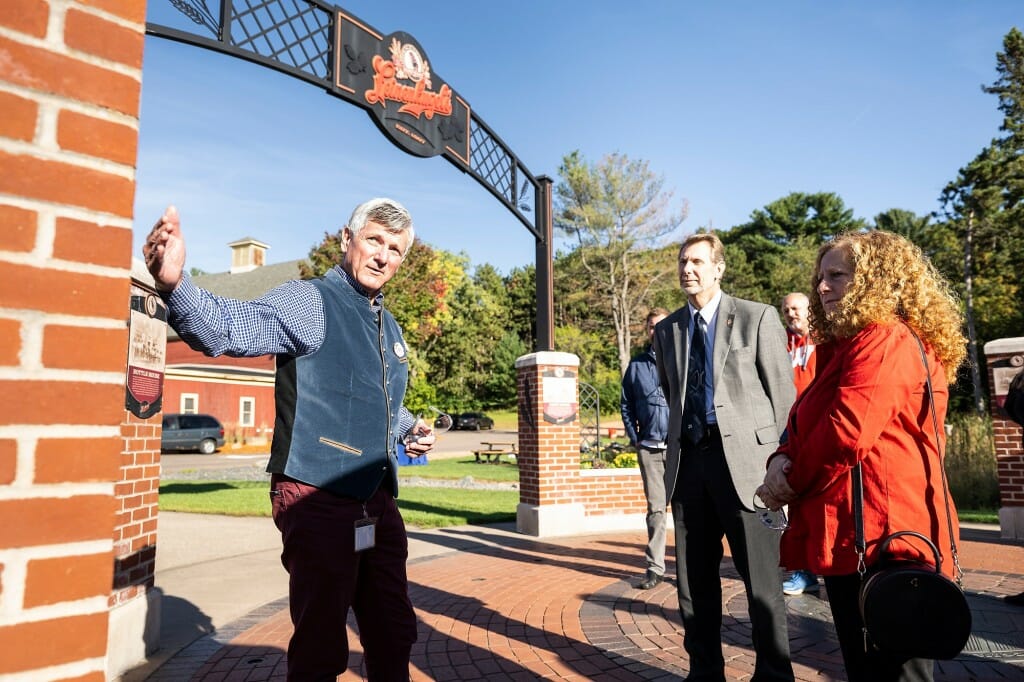 Dick Leinenkugel greets Charles Hoslet, Jennifer Mnookin and others at the gates of the Leinenkugel brewery.