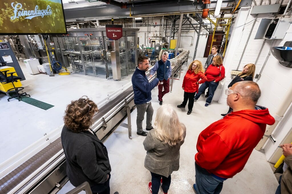 At center, Shawn Snedden talks with Jennifer Mnookin and others on the production floor of the Linenkugel brewery.
