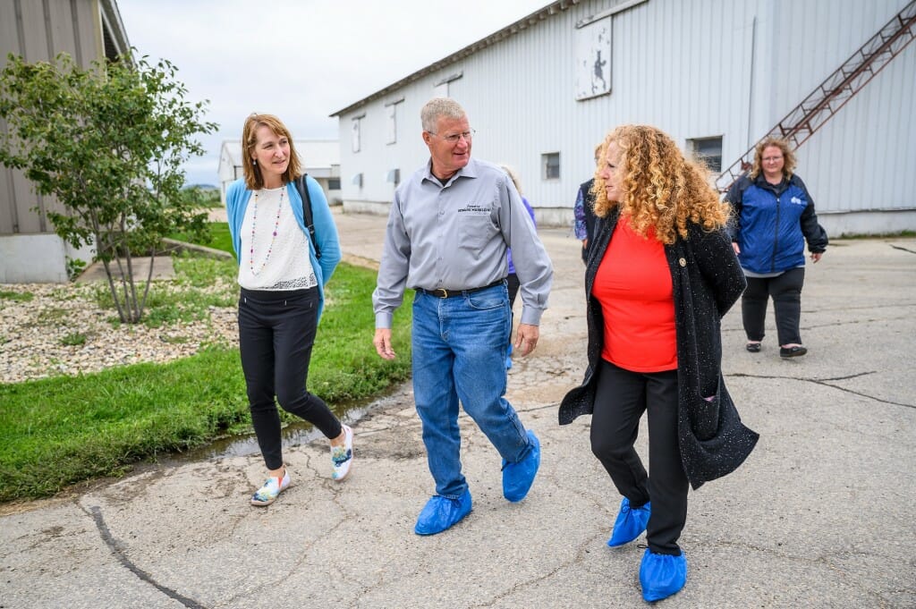 Chancellor Mnookin (right) walks with Wisconsin state Sen. Howard Marklein (center) and UW–Platteville Interim Chancellor Tammy Evetovich (left) during a tour of  Pioneer Farms.