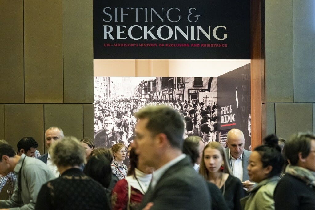 A crowd mills around the entrance to the Sifting and Reckoning exhibit.s