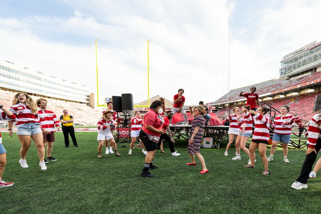 Sarah Schutt, chief alumni officer and executive director of the Wisconsin Alumni Association, shows first-year students she can dance.