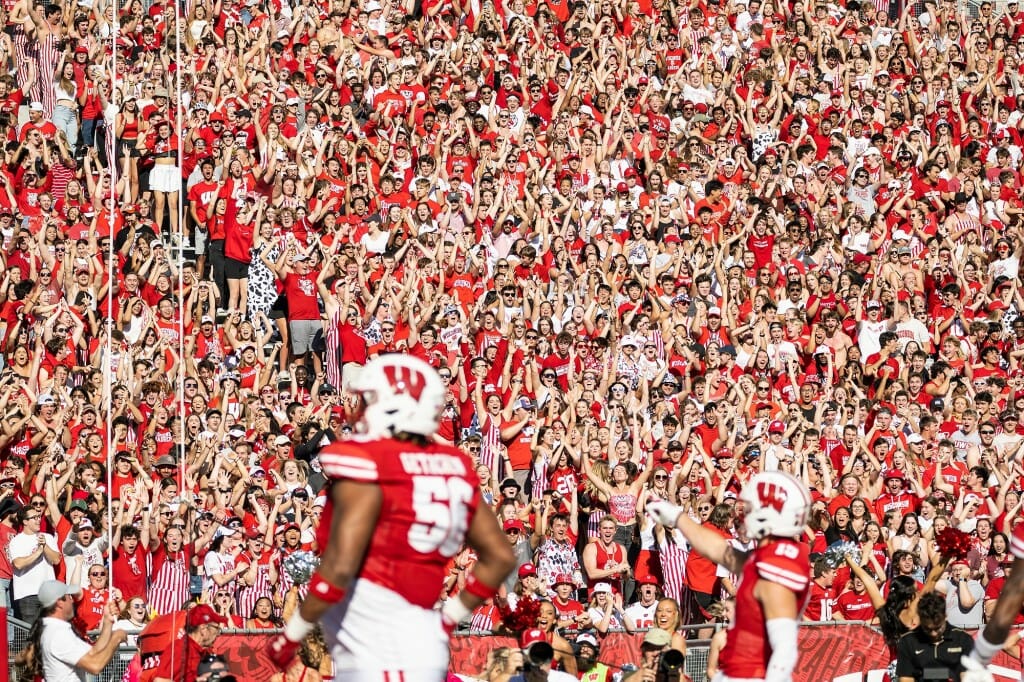 Badger fans cheer after Wisconsin safety John Torchio (15) ran an intercepted pass in for a touchdown in the first quarter.