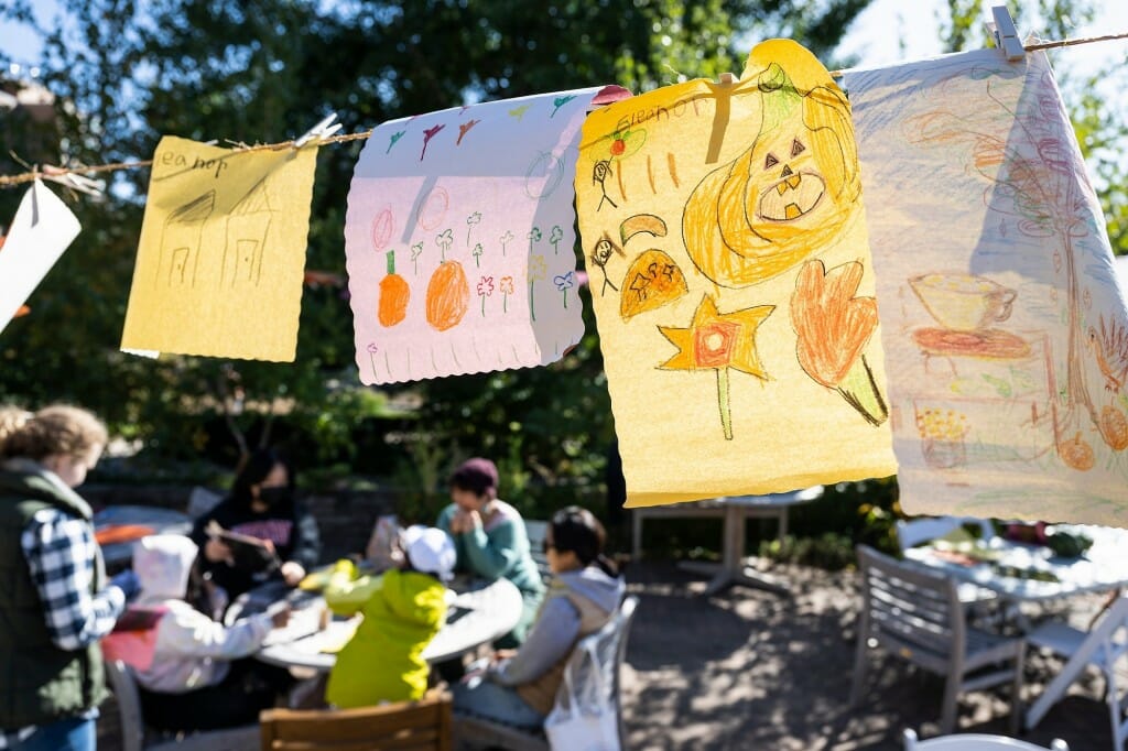 Visitor-created and plant-themed artwork hangs to dry during the Harvest Folk Festival.