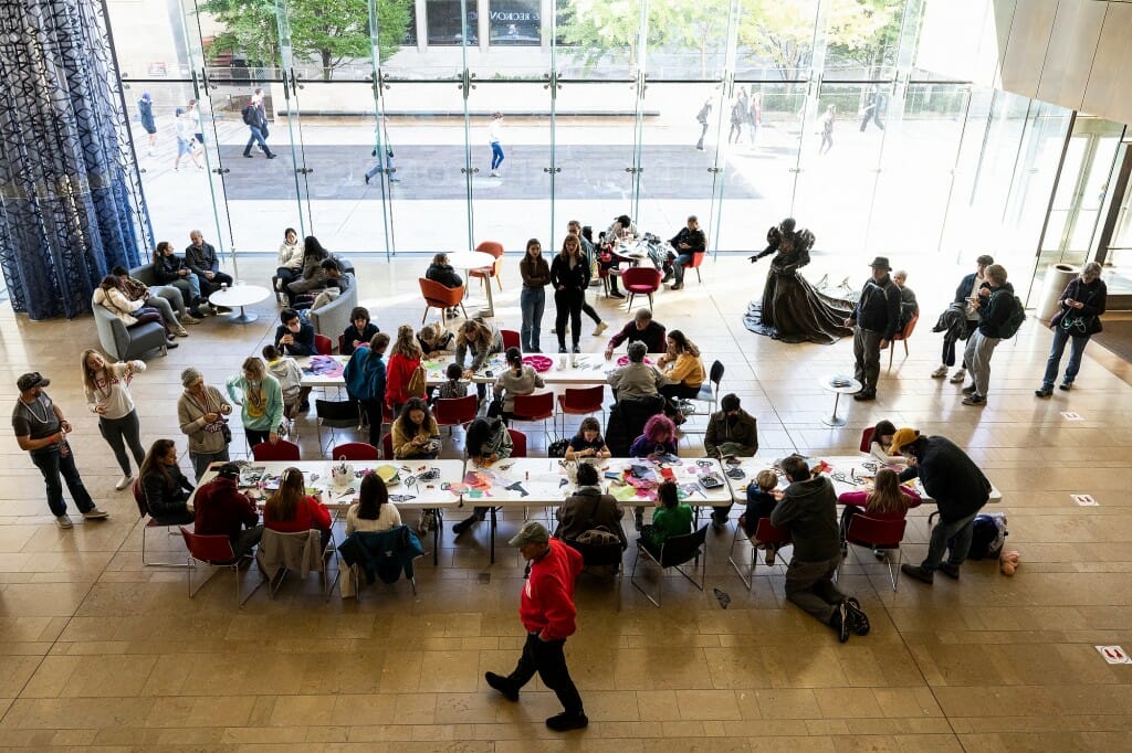 People work on craft projects at the Chazen Museum of Art during a Family Weekend event.