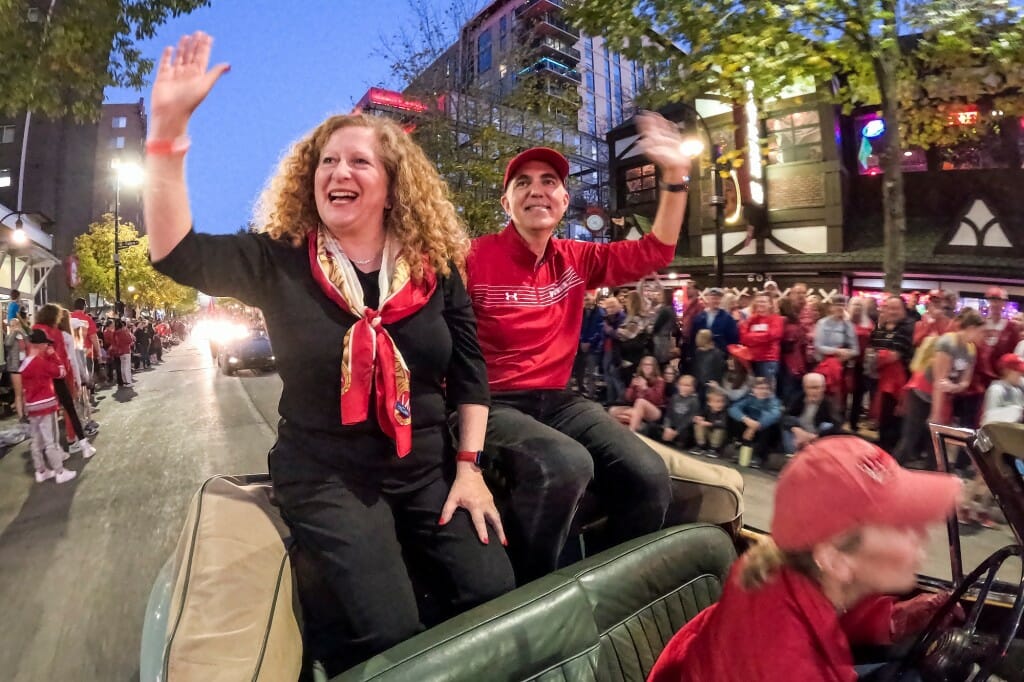 UW–Madison Chancellor Jennifer Mnookin and her husband, Joshua Foa Dienstag, wave to the crowd as they participate in their first Badger Homecoming Parade.