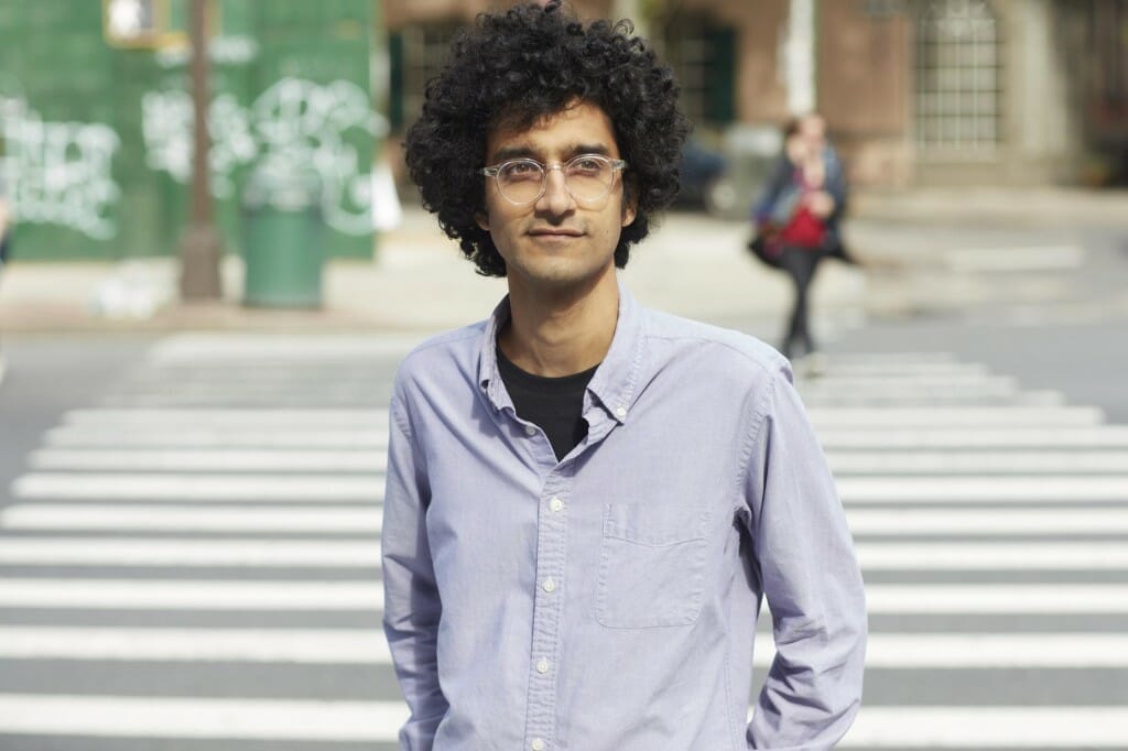 Latif Nasser stands in front of a city street crosswalk