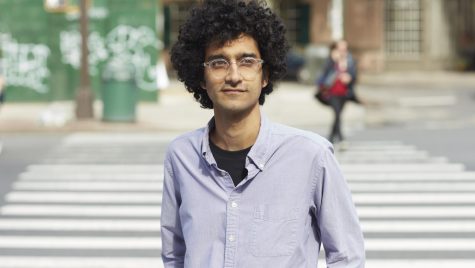 Latif Nasser stands in front of a city street crosswalk