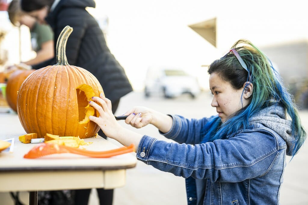 Student Rachael Lang cuts a bold design in her pumpkin.