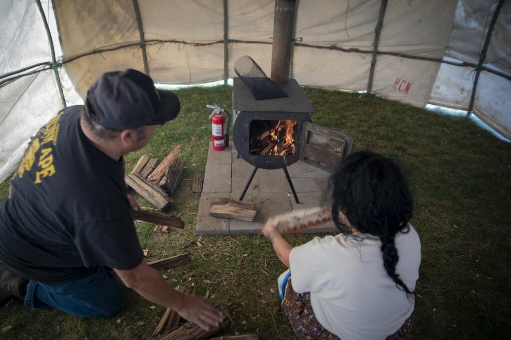 A fire is started to warm the interior.