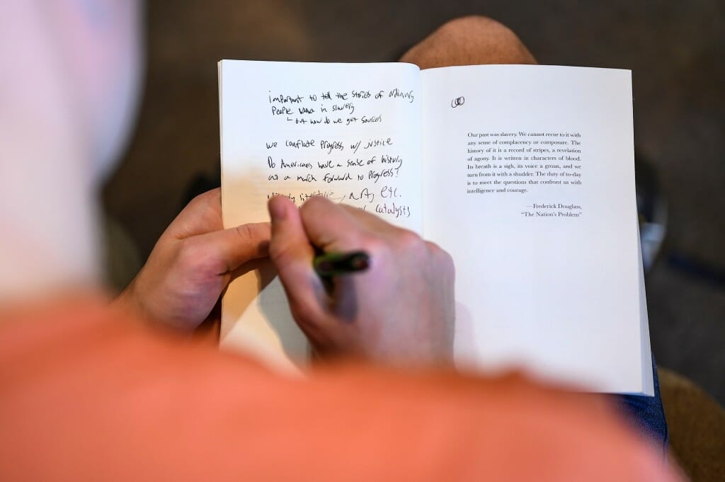 Undergraduate student Andrew Santamarina takes notes on the opening pages of his copy of “How the Word Is Passed.