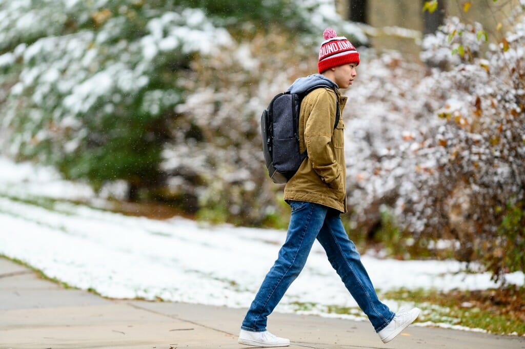 A student makes his way through the snowfall near  the Carson Gulley Center on Nov. 16.