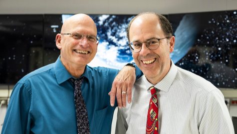“The Weather Guys,” also known as Steve Ackerman (left) and Jonathan Martin, both professors of atmospheric and oceanic sciences, are pictured in a weather-forecasting facility in the Atmospheric, Oceanic and Space Sciences Building.