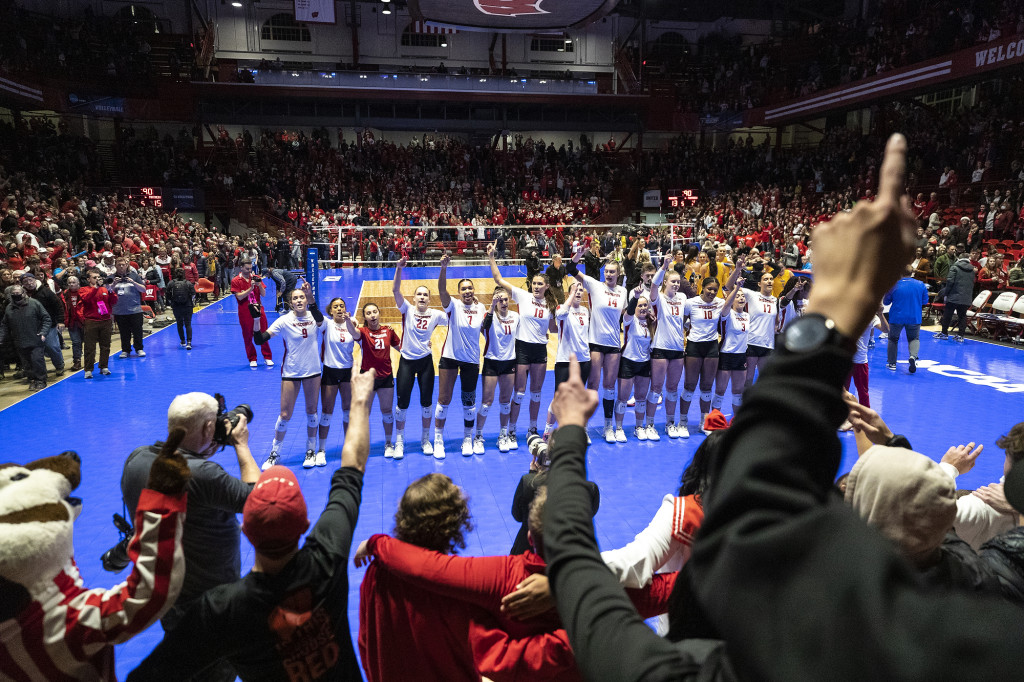 Fans sing Varsity with the Badger volleyball team for the last time this season after the match.