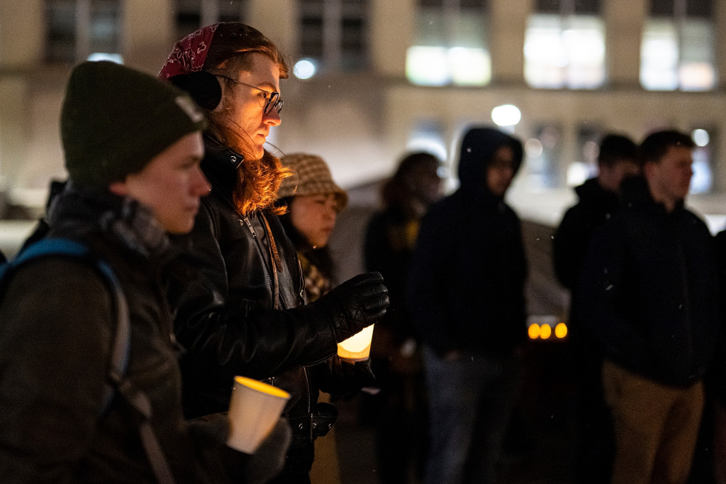 Students gather at night for a candle vigil on Library Mall.