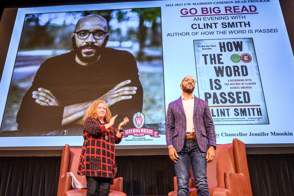 Jennifer Mnookin applauds Clint Smith as they stand on stage for his Go Big Read talk in Shannon Hall at Memorial Union.
