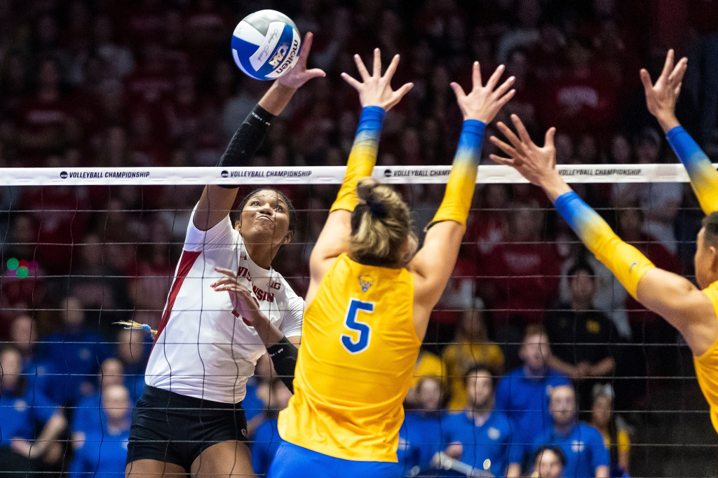 Devyn Robinson spikes a ball over the net in a volleyball match against Pittsburgh.