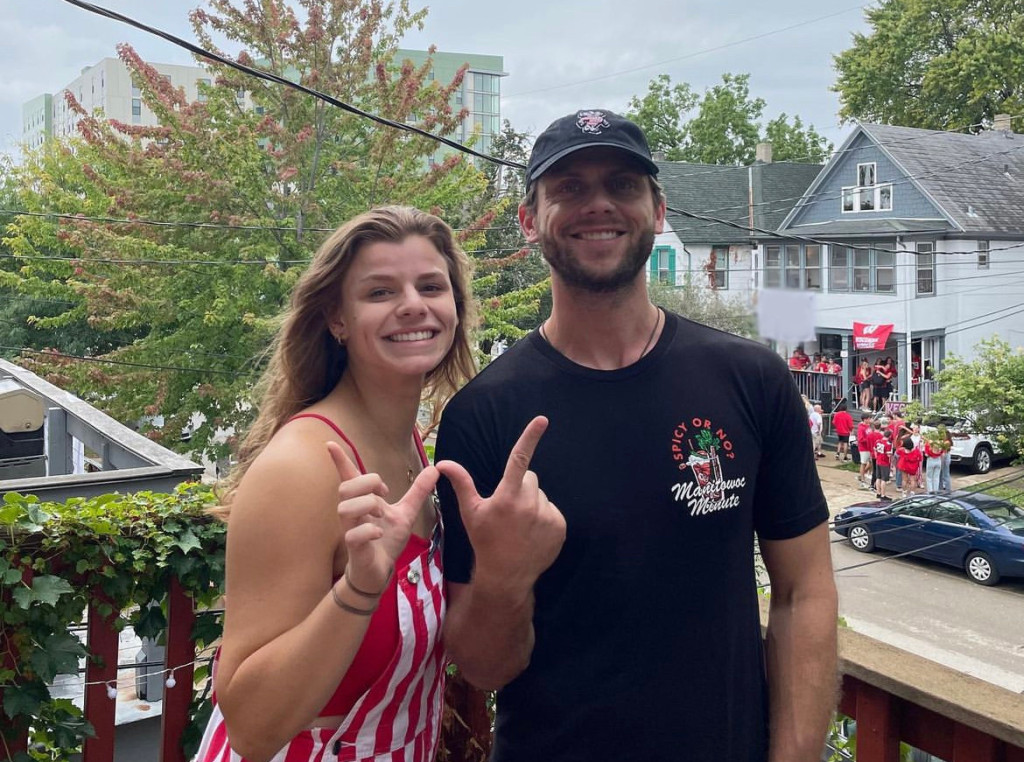 Bridget and Charlie Berens make a W sign with their thumbs and forefingers.