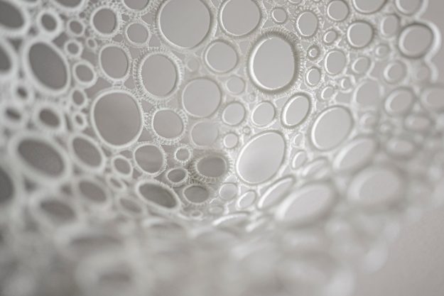A bowl made of interlocking fiberglass circles.