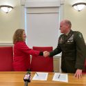 UW–Madison Chancellor Jennifer L. Mnookin and Brigadier General Dean Thompson, 353rd Civil Affairs Command, shake hands after signing an MOU document.