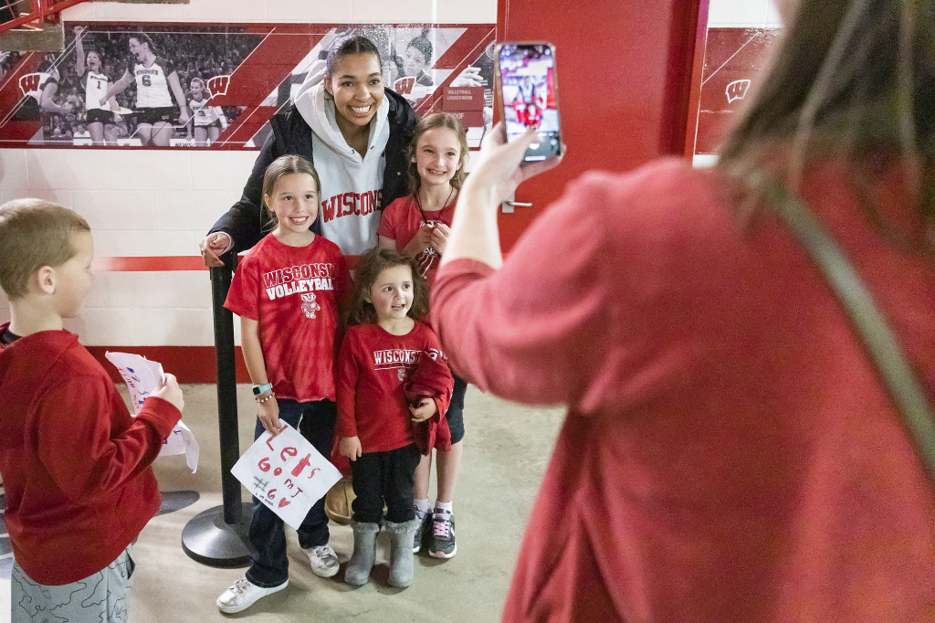 Gabby McCaa (#7) poses for a photo with some young fans after the Wisconsin Badgers volleyball team played against TCU in the TCU match.
