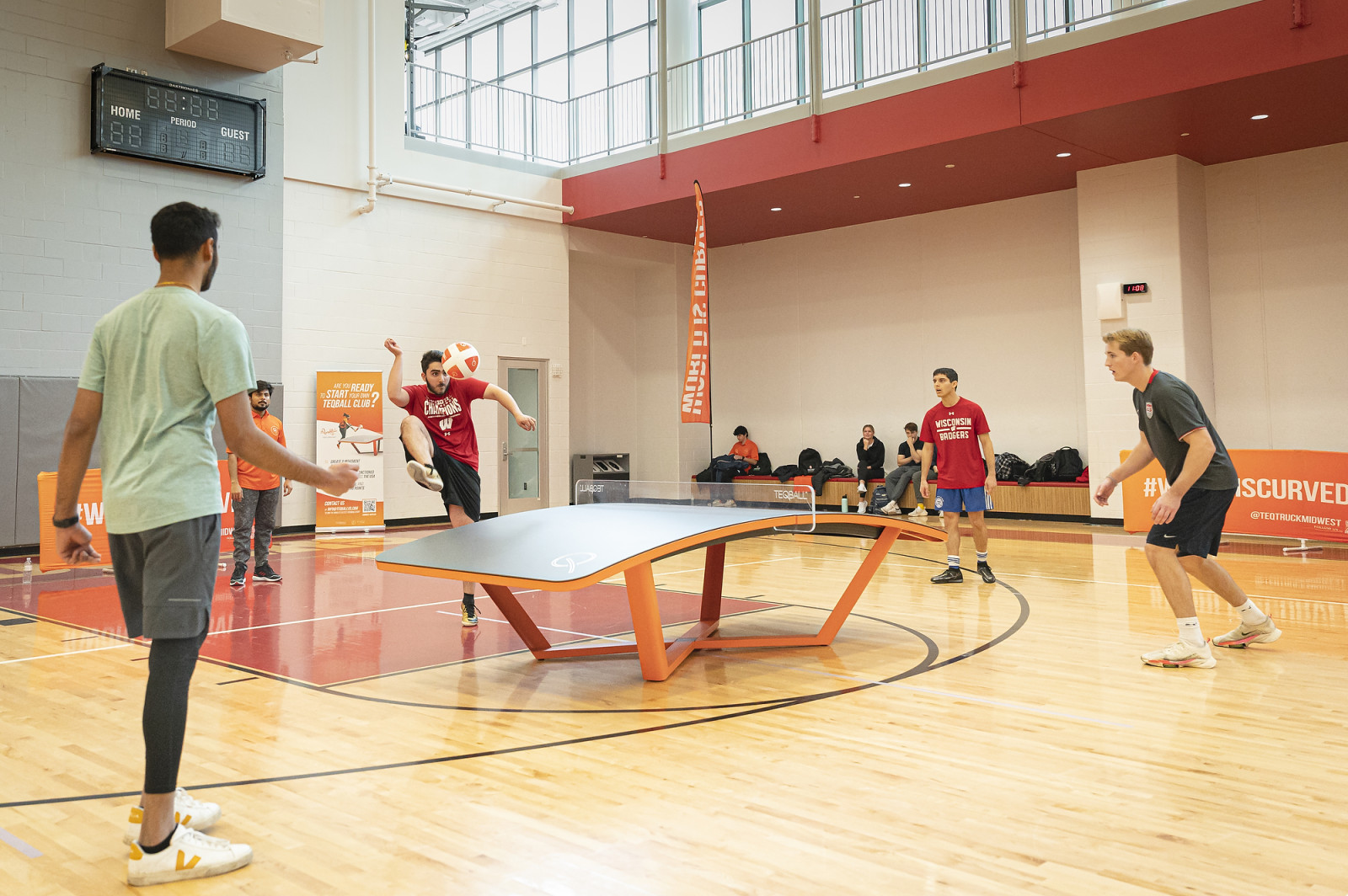 Two two-person teams in action during a teqball game