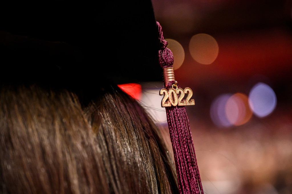 A 2022 charm and tassel adorn the mortarboard of a graduate.