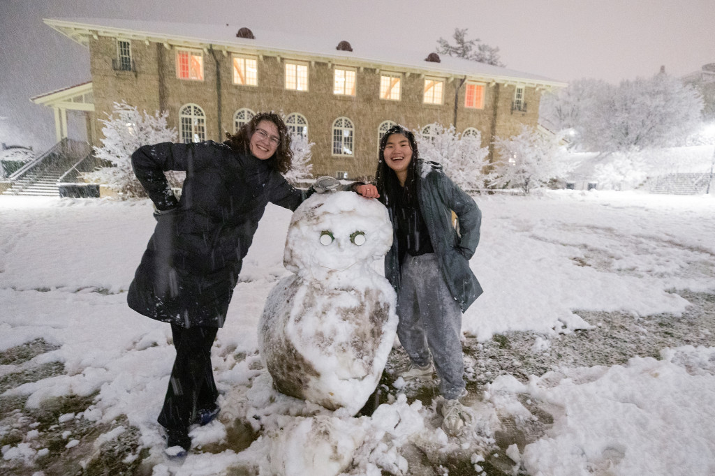 Jenna Crolla (left) and Minn Lee created a snow, er, owl with an intense stare, near Carson Gulley Center.