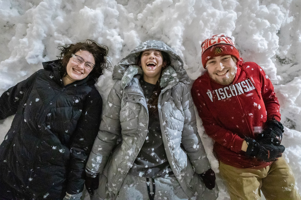 A soft snowbank was the perfect place to rest after all those snowy antics for, left to right, Jenna Crolla, Liv Baumann and Nick Mugnai.