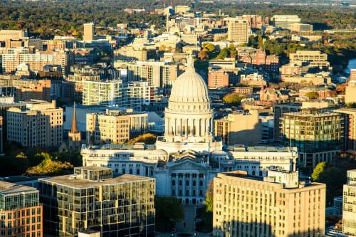 An aerial view of the Wisconsin State Capitol on a sunny day