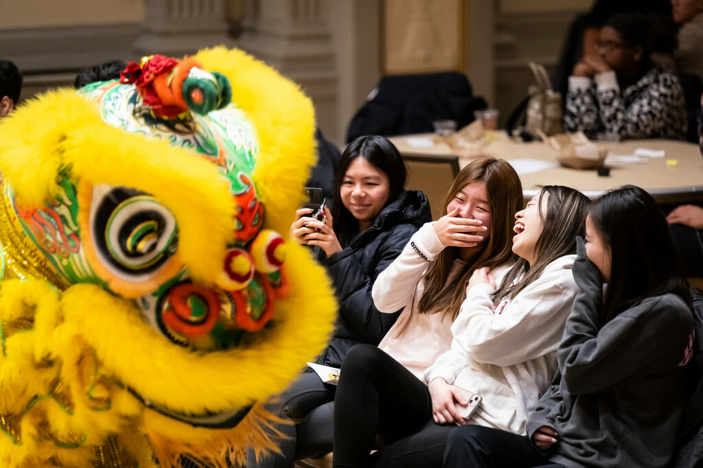 From left to right, first-year students Emily Mei, Rachel Hong, Priscilla Louey and Anna Chen react to a lion dancer from the Zhong Yi Kung Fu Association at the VSA celebration.