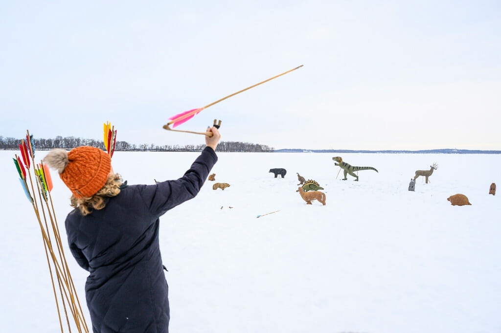 Michelle Konkol, a fourth-grade teacher from Stevens Point, uses an atlatl (spear thrower) to launch a spear toward a set of targets. Konkol teaches history to fourth graders and came down for the games to learn more about them.