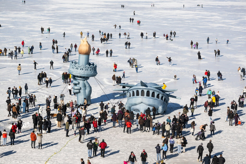 Hundreds of people visit and pose for photos with an inflatable replica of the Statue of Liberty’s head, arm and torch on Lake Mendota.