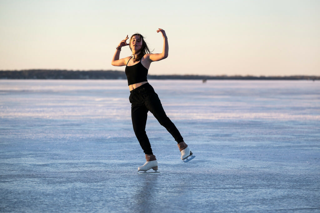 A woman skates on the ice.