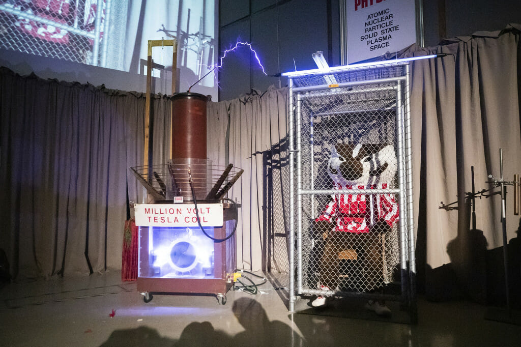 Bucky Badger demonstrates the effects of the Faraday cage, an enclosure that blocks electromagnetic fields.