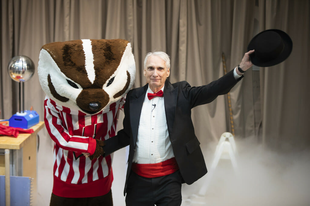 With an assist from Bucky Badger, Professor Clint Sprott takes a final bow after handing over control of the Wonders of Physics show to Haddie McLean.