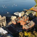 The University of Wisconsin-Madison campus is pictured in an aerial view looking east toward the downtown Madison skyline during an autumn sunset