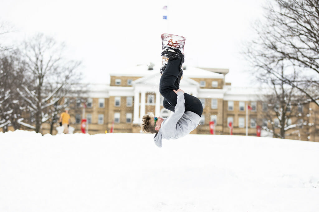 Student A.J. Beery catches some air while snowboarding on Bascom Hill.