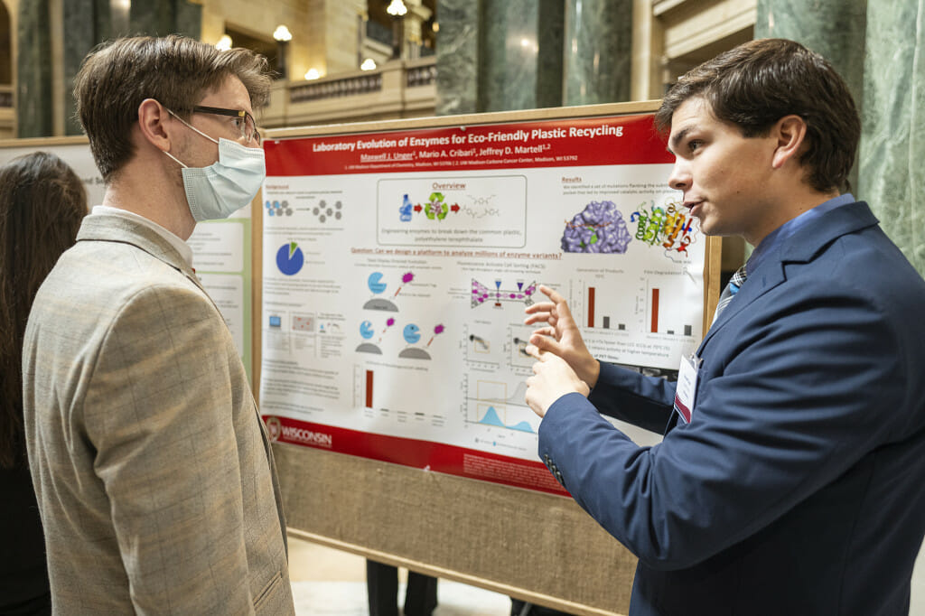 UW–Madison senior Maxwell Unger, right, talks about his research project done with Mario Cribari, called 