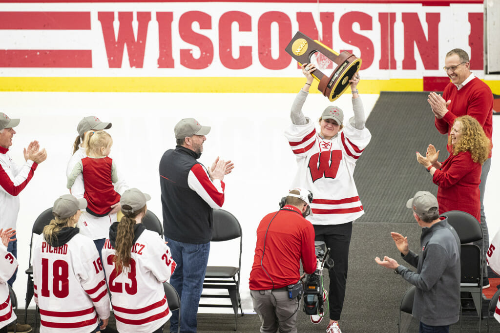 Goalie Cami Kronish (30) raises the championship trophy above her head. Kronish was named the Most Outstanding Player of the 2023 NCAA Frozen Four following her shutout game against Ohio State in the championship game.