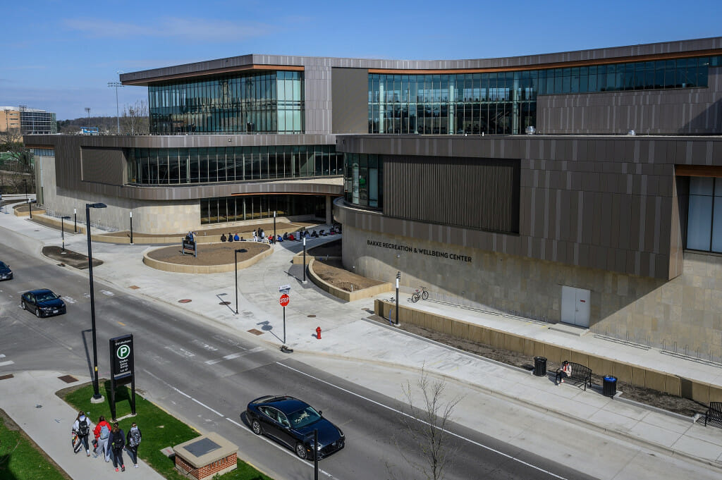 A view of the entire Bakke building, with a line of student visible out front.