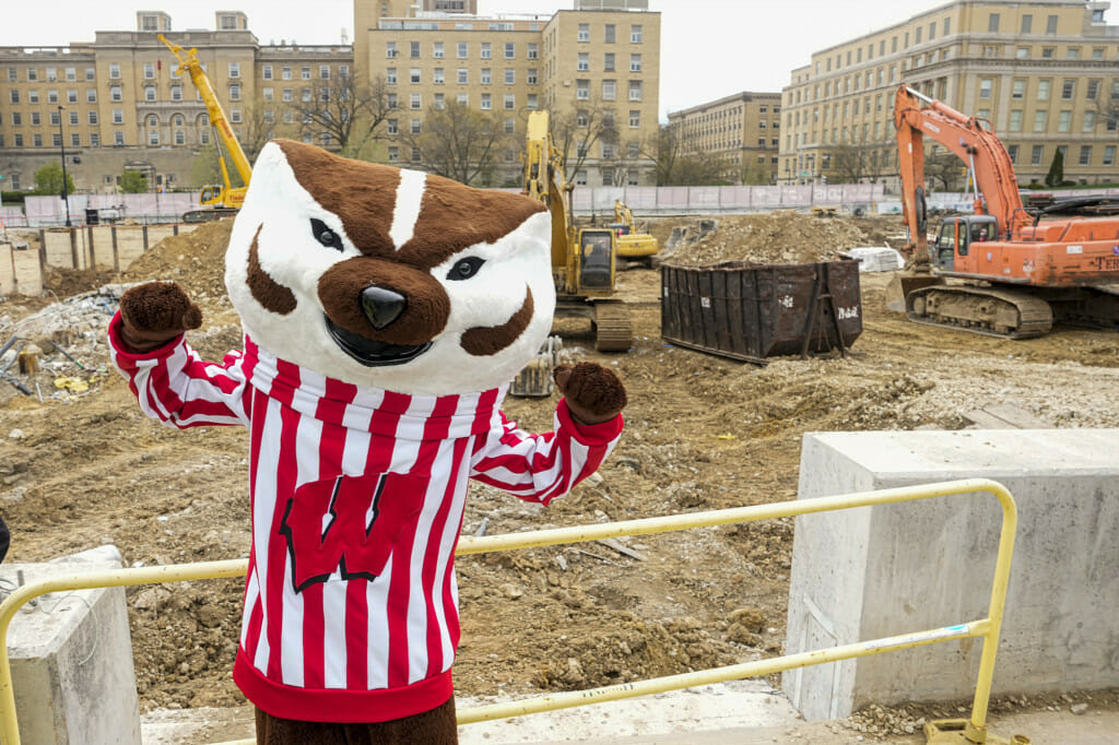 Bucky Badger stands in front of the construction site of the new CDIS building. PHOTO BY ANDY MANIS